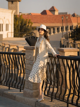 A lady wears a worsted wool blazer